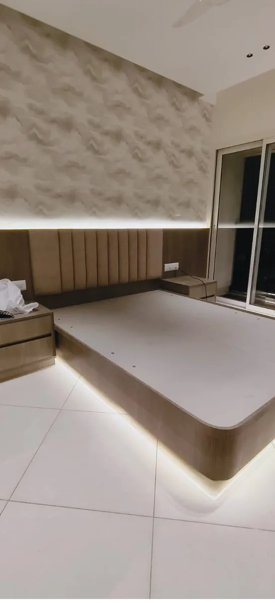 Floating platform bed with concealed perimeter LED illumination and custom vertical fluted headboard