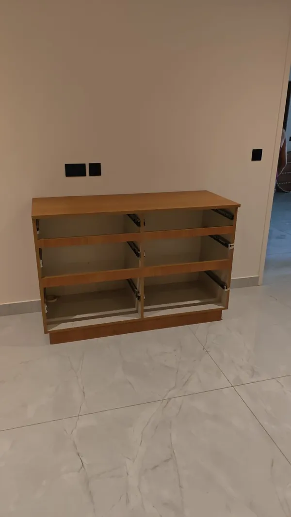Interior layout of modular wardrobe featuring hanging rails, shelf dividers, and drawer units