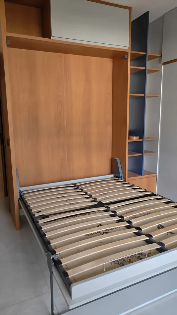 Warm wood-grain and cream laminate cabinetry during final hardware alignment