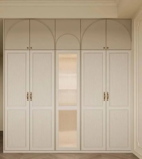 Living room accent wall with vertical fluted paneling and low-profile floating credenza