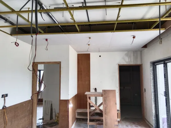 Step-down drywall ceiling with recessed perimeter pocket designed for concealed LED cove strip lighting