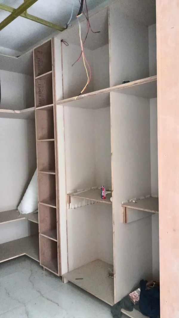 Vertical plywood wall panelling backing mounted behind the master bed position
