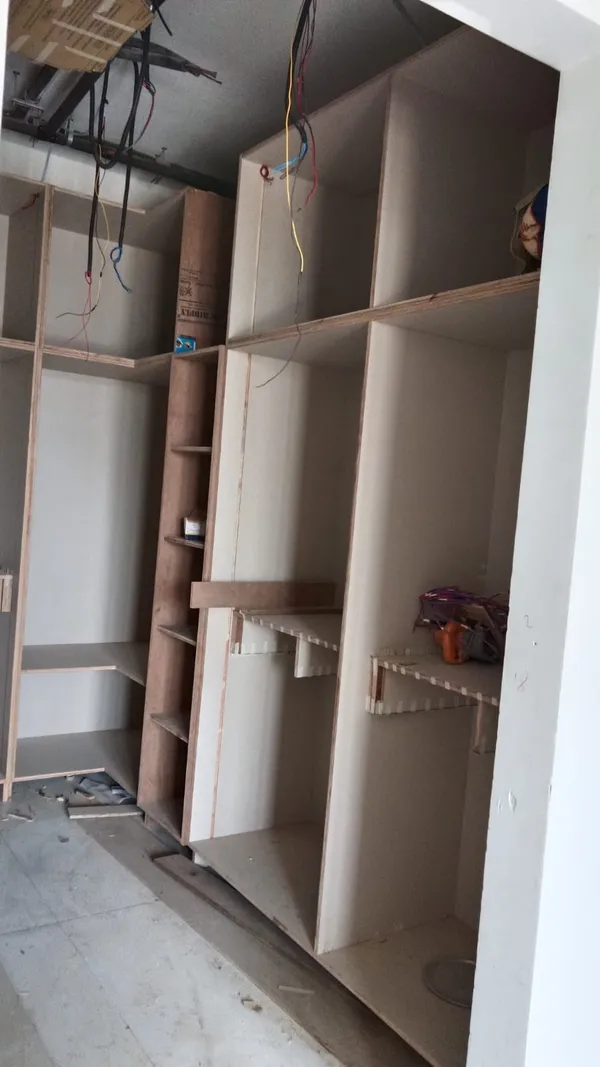 Close-up detail of smooth CNC-routed arched plywood contours for feature entertainment wall